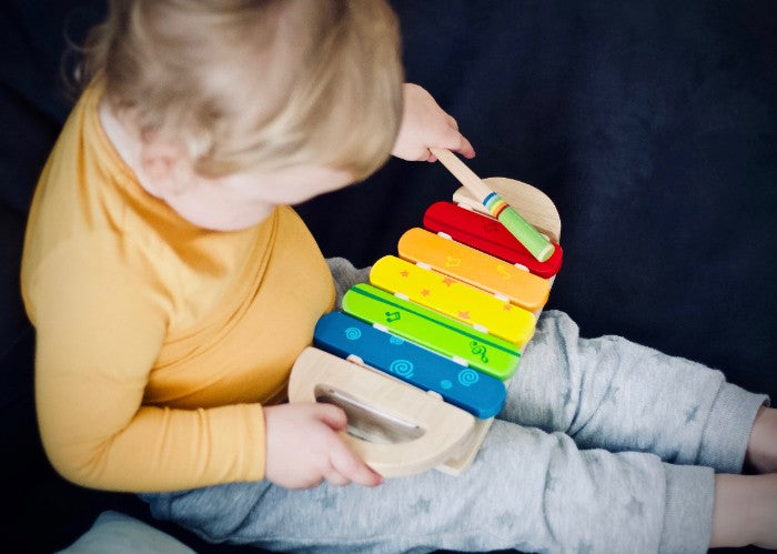 toddler playing instrument