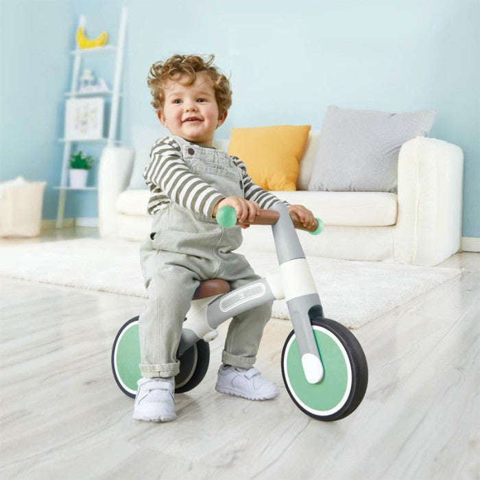 toddler riding indoor tricycle