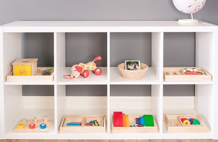 toys stored on a shelf in a toddler's playroom