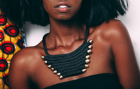 Close up of woman wearing The Fan necklace