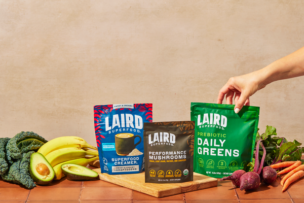 Laird Superfood products displayed with bananas, kale, avocado, and other healthy food ingredients