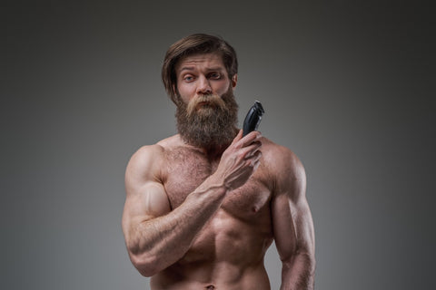 Man with beard holding a trimmer