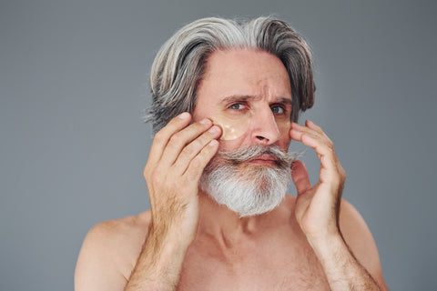Bearded man cleaning his face