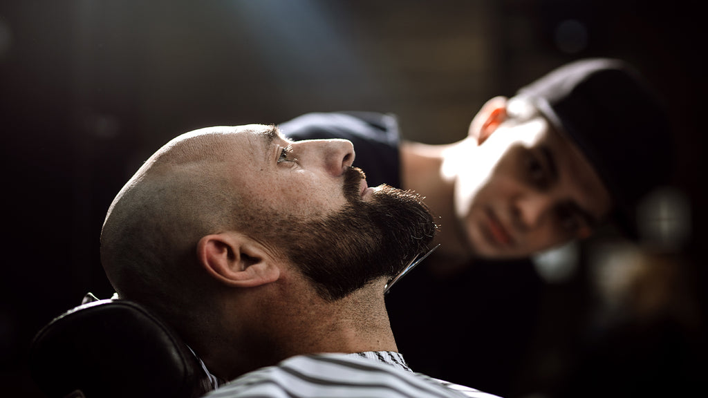 Man getting groomed in barber chair