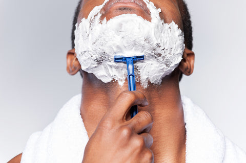 Man shaving below his jawline