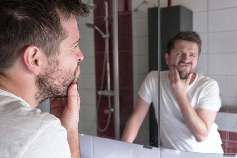 Man using beard care products as part of his routine