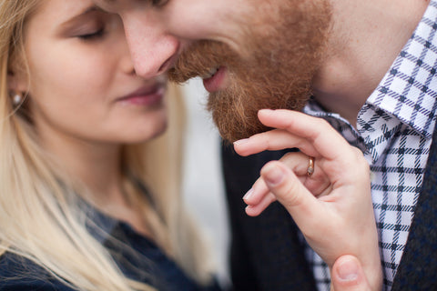 Bearded guy with wife touching a smooth beard