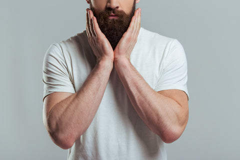 Man shaping his beard with beard care products