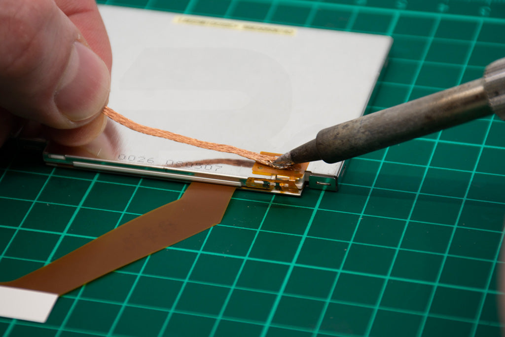 Remove excess solder from solder pads