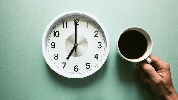 a clock and a cup of coffee