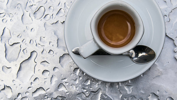 a cup of coffee with metal and water background. 