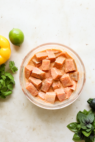 Salmon marinating in curry sauce