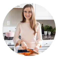 Blogger Marisa in her kitchen cutting vegetables