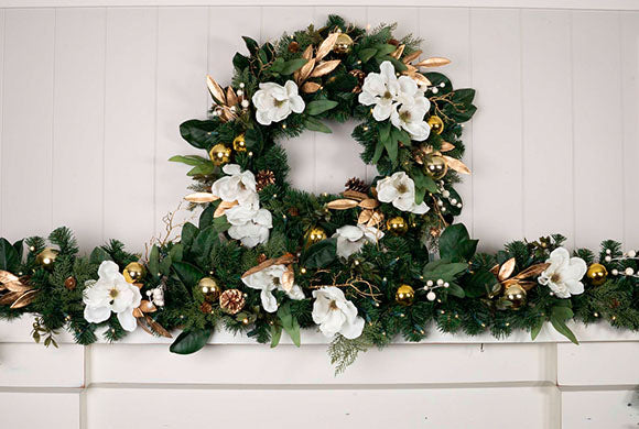 White Gold Magnolia Wreath and Garland Hanging Above Fireplace Mantle