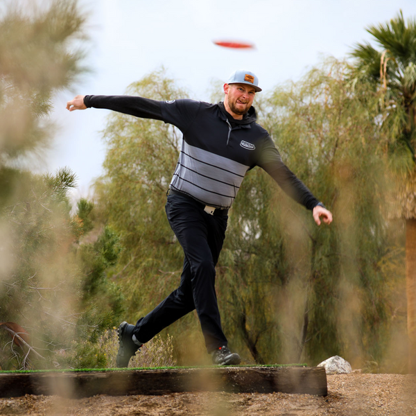 Disc golf is a very accessible sport: almost all courses are free to play. Pictured is a disc golf player throwing a disc.