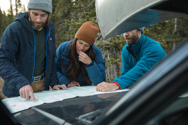 Hikers plan their next excursion, wearing their ultralight belts from GRIP6. 