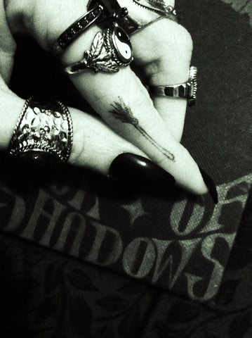Image of broon on my witchy finger over book of shadows 