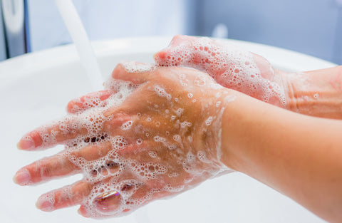 Washing hands in sink