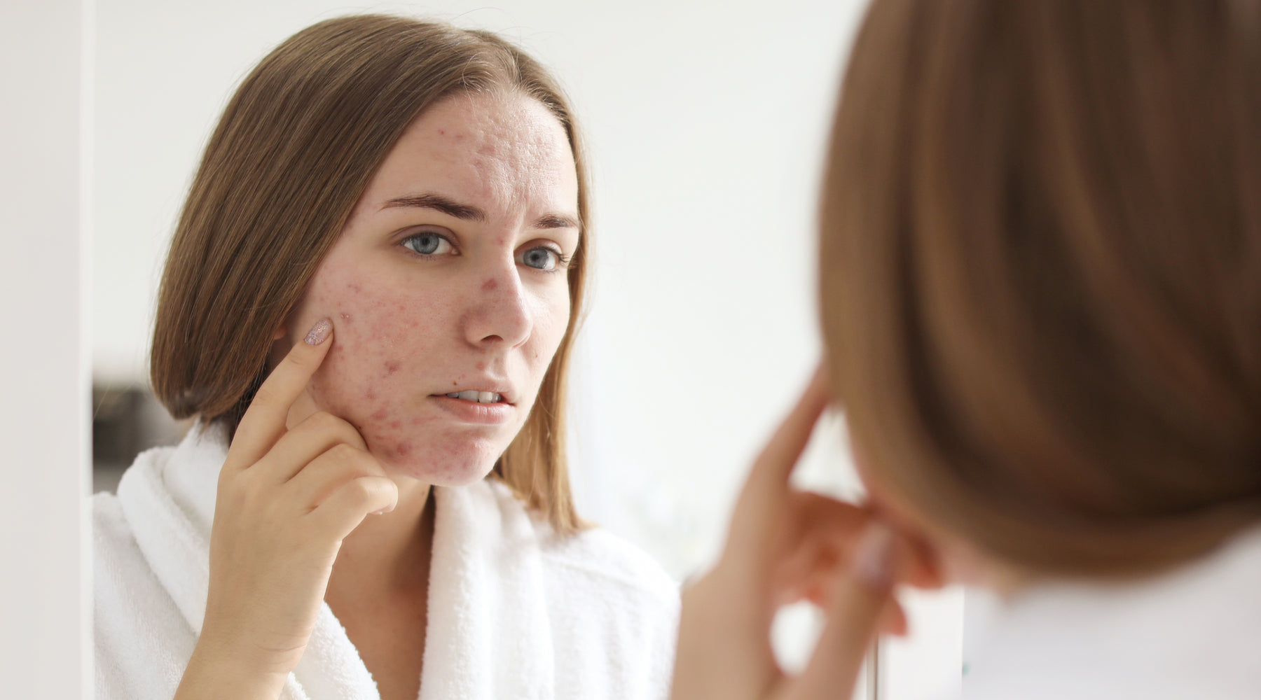 Woman examining her skin 