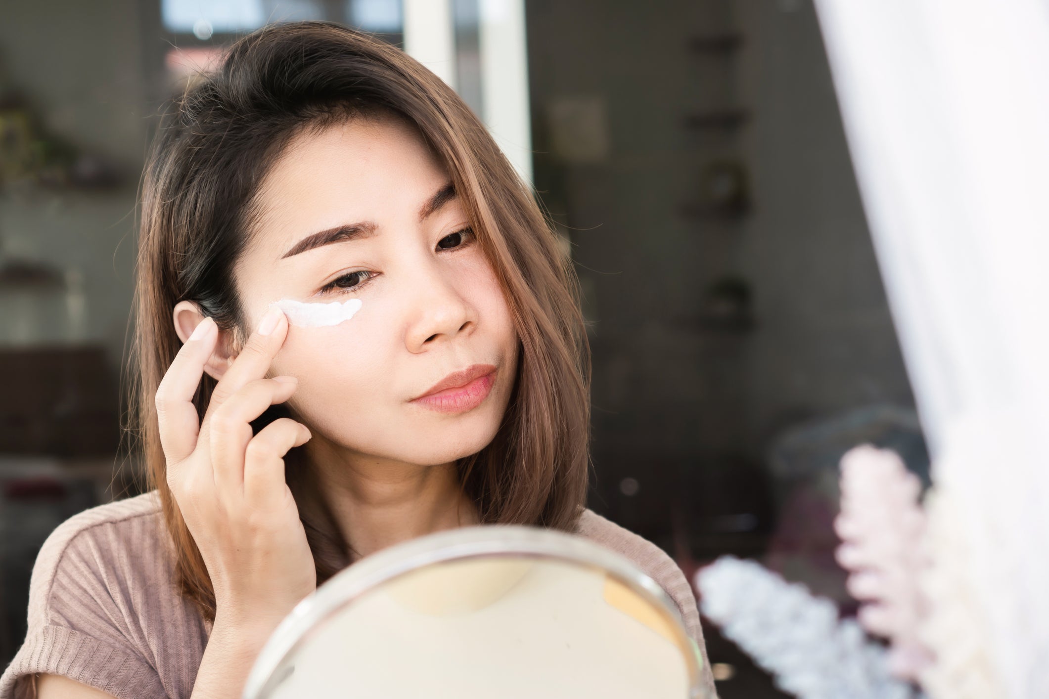 Woman applying eye cream