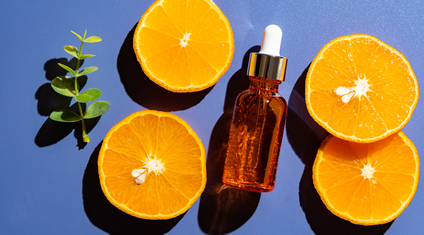 Bottle surrounded by citrus fruit.