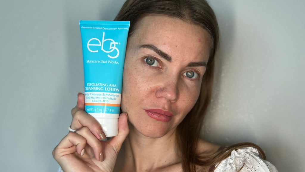 A woman holding the eb5 Exfoliating Cleansing Lotion. 