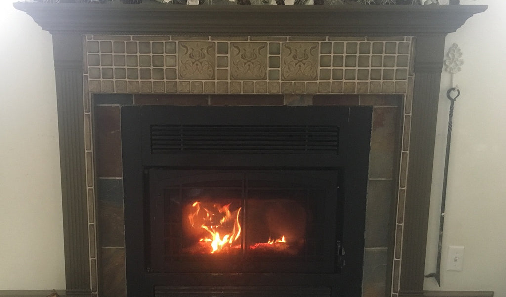 Tan and chestnut brown tiles for fireplace surround with handmade art tile accent tiles in art nouvea style.  Brownstone glaze from Campbell Tileworks