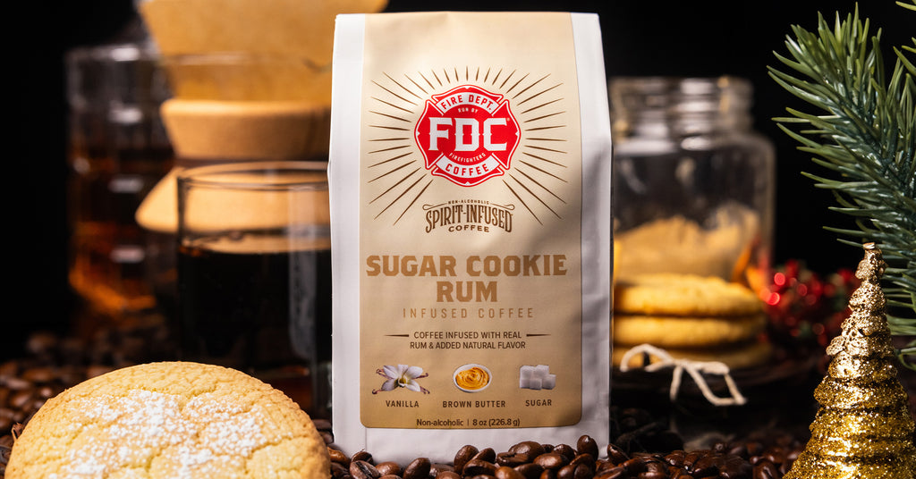 Close up of Sugar Cookie Rum Infused Coffee bag surrounded by holiday decorations.
