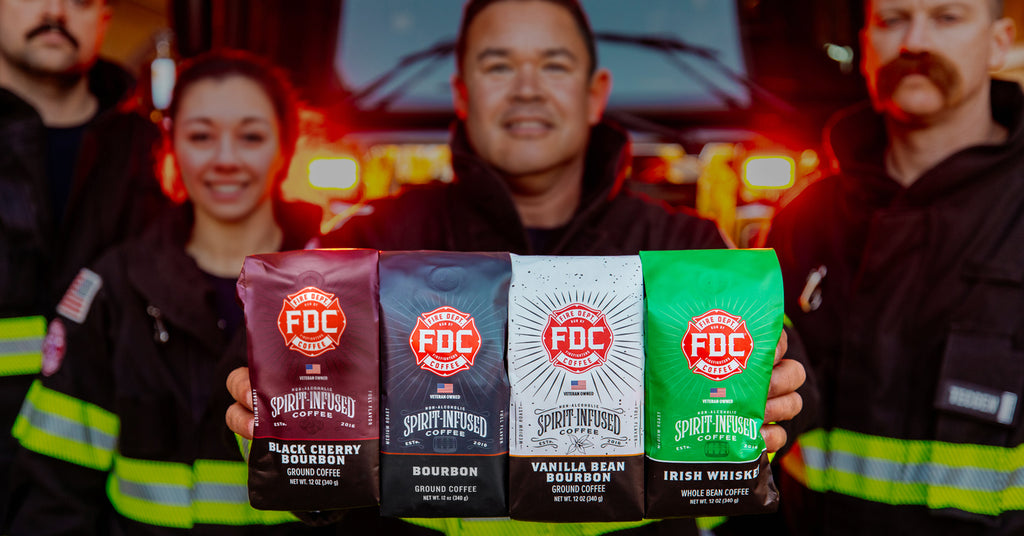 Firefighters holding four bags of Spirit Infused Coffee.