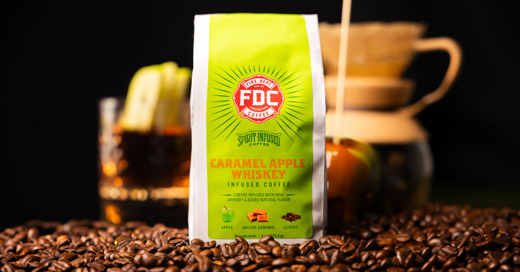 Bag of Caramel Apple Whiskey Infused Coffee surrounded by coffee beans.