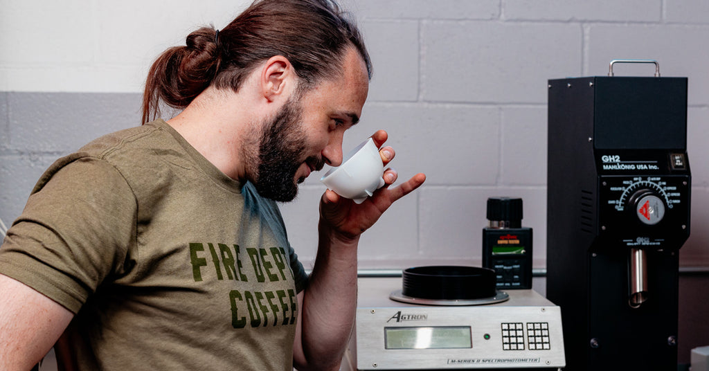 Jacob Ball cupping and testing coffee at the Fire Dept. Coffee roastery.