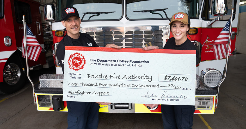 Members of Poudre Fire Authority holding a donation check.