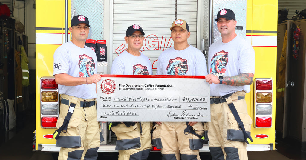 Hawaii firefighters holding a ovesided donation check.