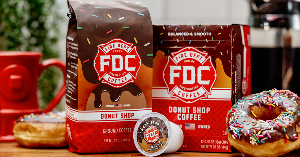 A coffee bag and coffee pods box of Donut Shop Coffee surrounded by donuts.