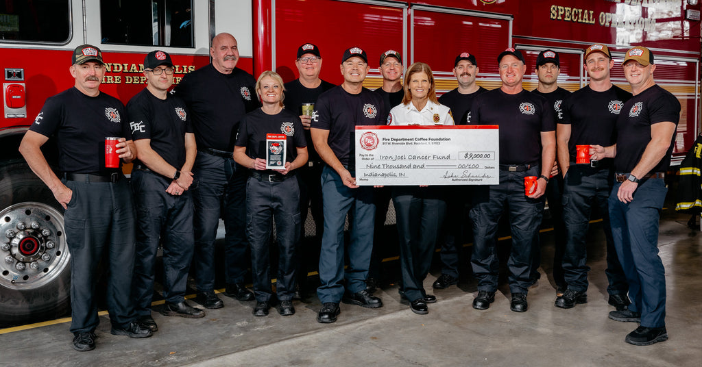 A group of firefighters holding a donation check.