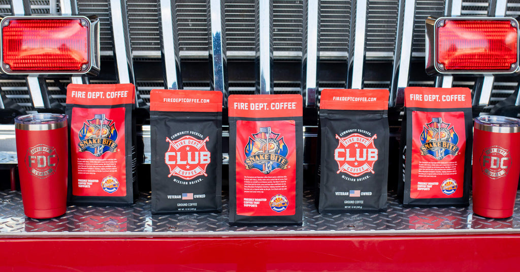 Coffee bags and thermal tumblers on the front bumper of a fire truck.