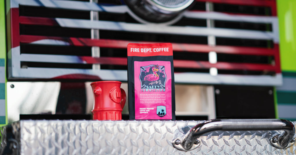 Pink coffee bag featuring a flamingo sitting on the back of a fire truck.