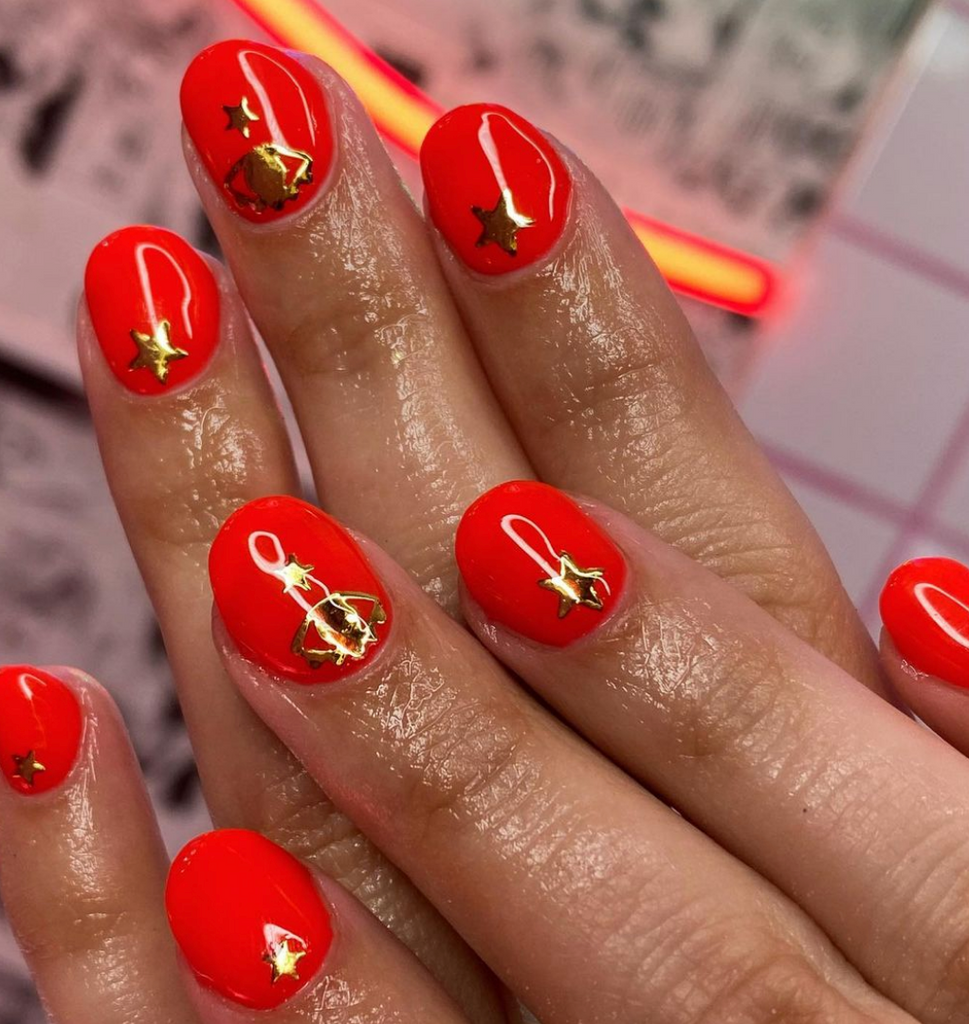 red nails with gold stickers