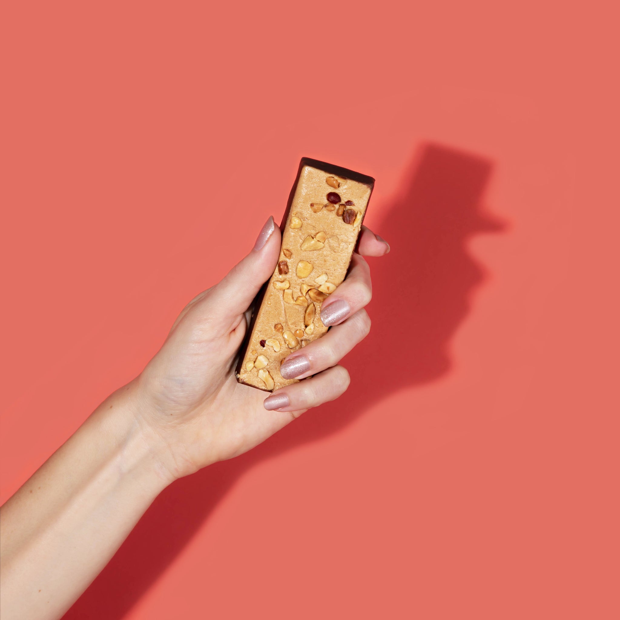 hand holding FitJoy protein bar