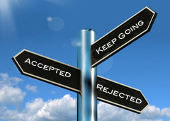 A poll with three street signs, they say 'accepted' 'rejected' and 'keep going'