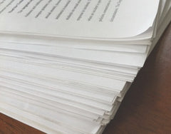 A closeup photo of a stack of typewritten pages