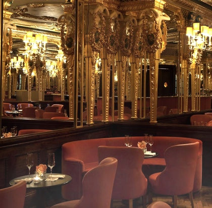 A luscious little corner of the Oscar Wilde tearoom, with red velvet seating and mirrors and gold accents everywhere