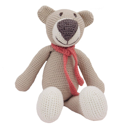 Knit beige bear with brown nose, white feet and a orange/pink scarf