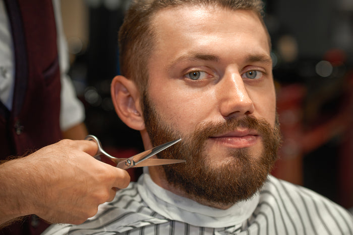 man getting styling of beard
