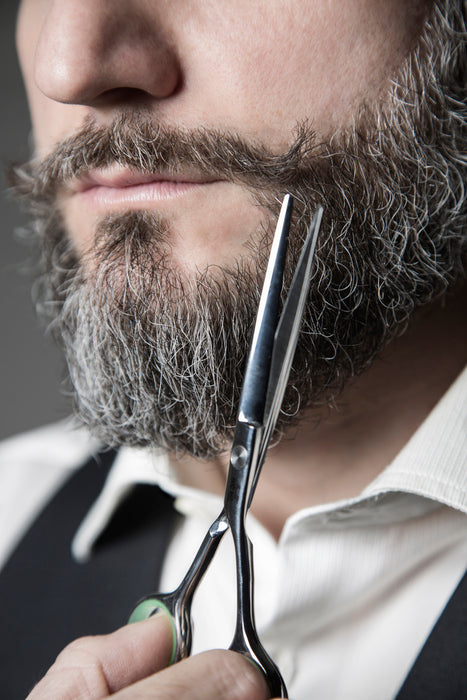 man trimming beard