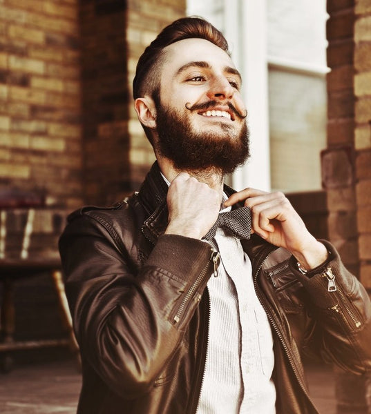 man with a verdi beard wearing a jacket