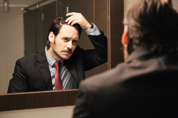 businessman touching his hair