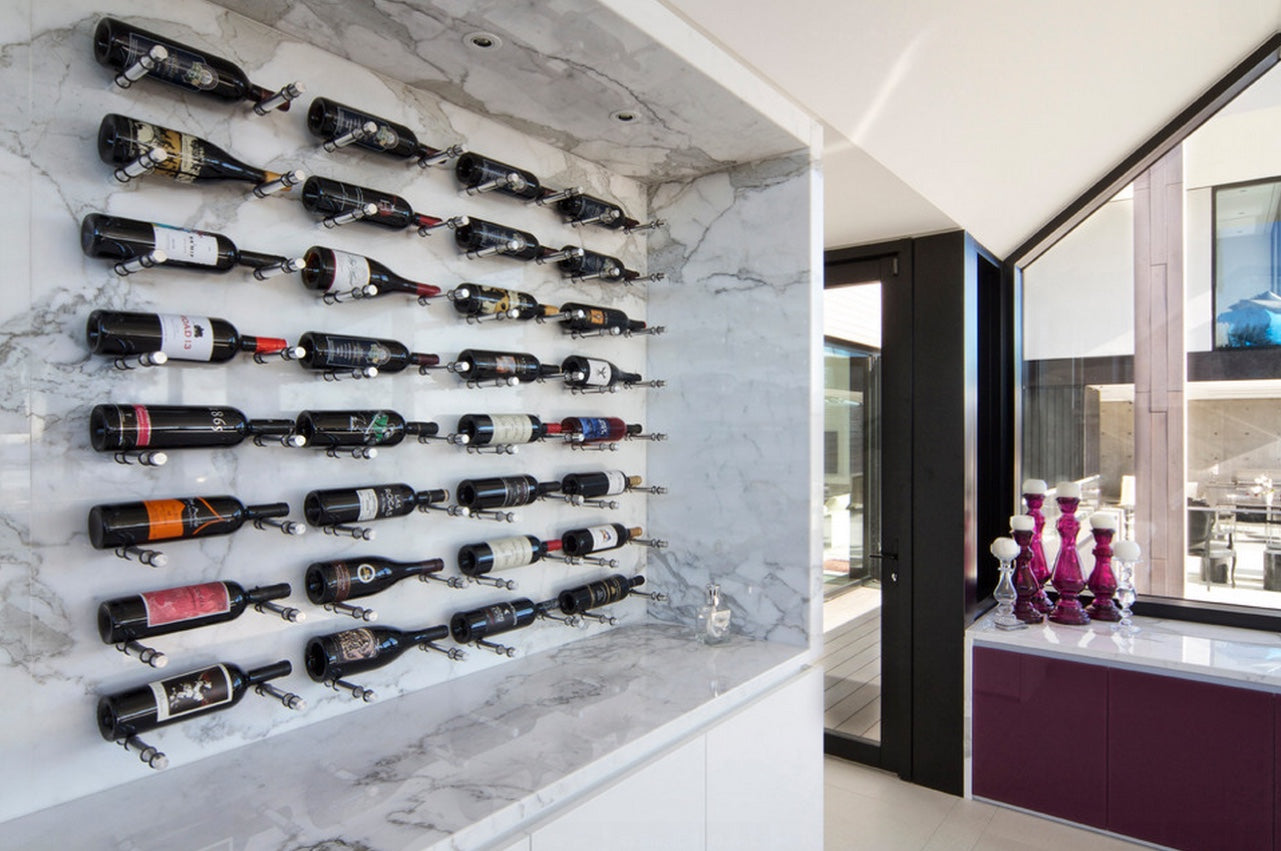 Modern wine rack display system on a marble wall.