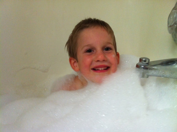 Young Boy Relieving His Eczema in a Milk Bath