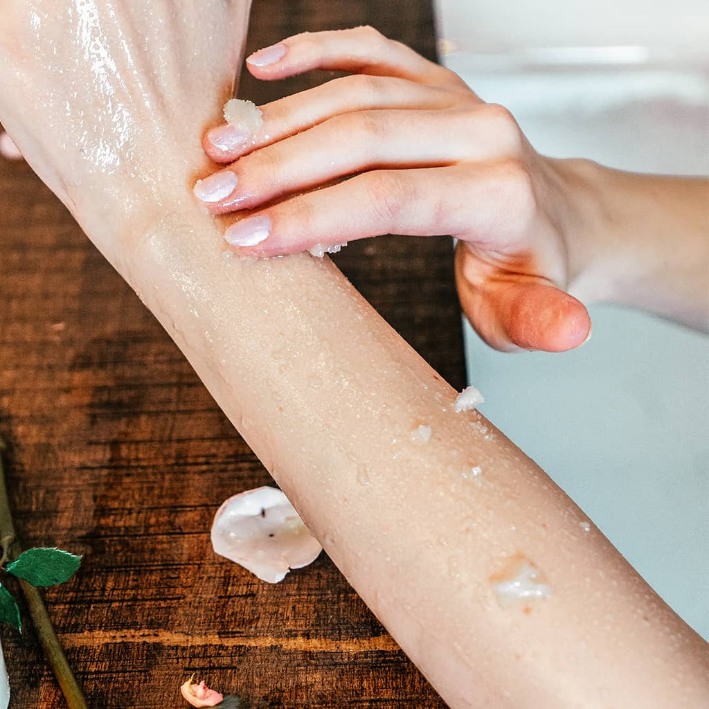 Woman Exfoliating Her Arm With All-Natural Sugar Scrub